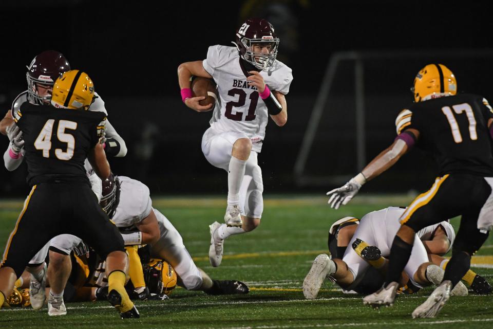 Wyatt Ringer #21 of the Beaver Bobcats carries the ball in the first half during the game against the Montour Spartans at Thomas J. Birko Memorial Stadium on October 22, 2021 in McKees Rocks, Pennsylvania.