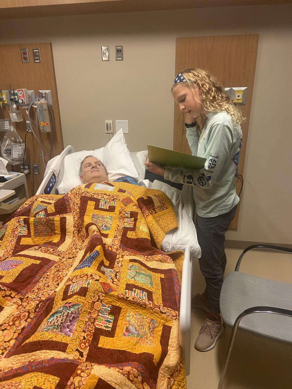 Grace Kolb reads a poem she wrote for her father, Jason Kolb, during his rehabilitation at a hospital in Colorado. Jason Kolb was paralyzed from the waist down in a skiing accident in January 2023.