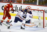 Edmonton Oilers goalie Mikko Koskinen, right, looks back at the puck on a goal by Calgary Flames forward Matthew Tkachuk during the second period of Game 1 of an NHL hockey second-round playoff series Wednesday, May 18, 2022, in Calgary, Alberta. (Jeff McIntosh/The Canadian Press via AP)