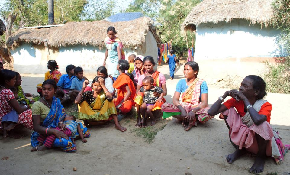 Santhal tribal women gather in a village where a woman was gang raped, allegedly on the direction of a village council at Subalpur, in Birbhum district, about 180 kilometers (110 miles) north of Kolkata, the capital of the eastern Indian state of West Bengal, Friday, Jan. 24, 2014. The woman told police that Monday's attack came as punishment for falling in love with a man from a different community and religion. Across much of rural India, these powerful and deeply conservative local councils are the law of the land. They serve as judge and jury, dictating everything from custody cases to how women should dress to whether young lovers deserve to live or die. (AP Photo)