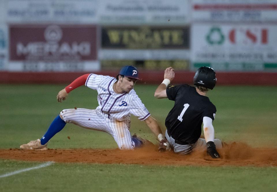 Shortstop Alex McCranie (5) gets set to tag Caden Kelly (1) out as he tries to steal second base during the Tate vs Pace 6A District 1 championship baseball game at Pace High School on Thursday, May 5, 2022.
