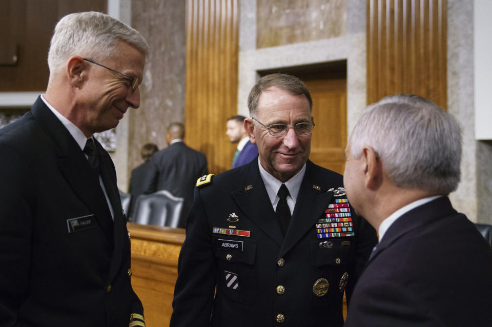 Gen. Robert Abrams, center, and Navy Vice Adm. Craig Faller, left, talks with Senate Armed Services Committee ranking member Sen. Jack Reed, D-R.I., after a hearing on Capitol Hill in Washington, Tuesday, Sept. 25, 2018. Gen. Abrams is nominated to take command of U.S. and allied forces in South Korea and Navy Vice Adm. Faller is nominated to take over U.S. Southern Command. Gen. Abrams says the decision to cancel several major military exercises on the Korean peninsula this year caused a slight degradation in the readiness of American forces. (AP Photo/Carolyn Kaster)