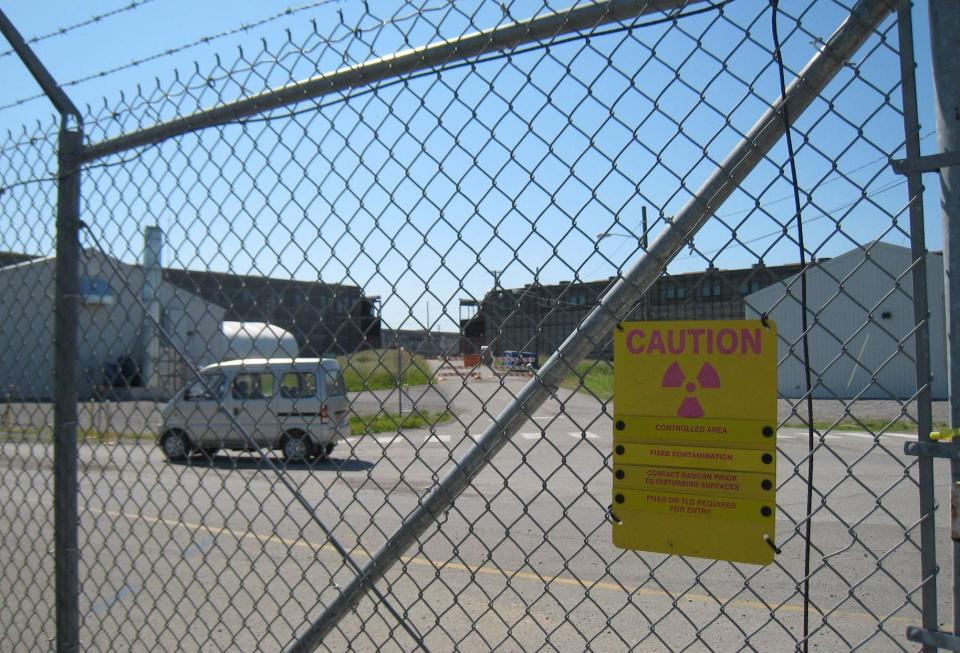 The Department of Energy's K-25 uranium enrichment plant in Oak Ridge, Tenn., has been shut down since 1963, but access remains limited as shown in this Thursday, May 22, 2008 photo. A small break between the building's wings in the background shows the progress of demolition expected to be completed in late 2010. The projected cost to clean up the entire 1,500-acre site is $3 billion.