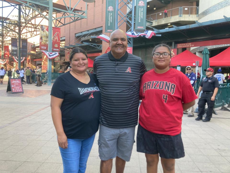 Fans Sheryl Kane, Rey Acosta and Tewa Acosta arrive at Chase Field for the Diamondbacks game against the Dodger on Oct. 11, 2023.