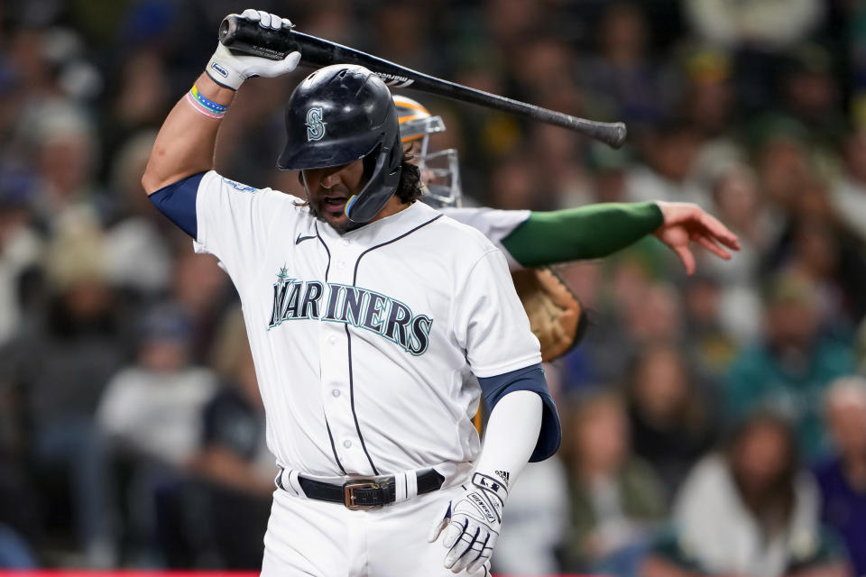 Seattle Mariners' Eugenio Suarez prepares to throw his bat to the ground after striking out against the Oakland Athletics during the seventh inning of a baseball game Tuesday, Aug. 29, 2023, in Seattle. (AP Photo/Lindsey Wasson)