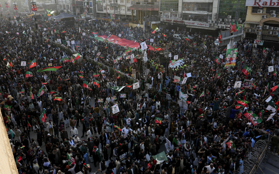 Supporters of Pakistan's former Prime Minister Imran Khan's 'Pakistan Tehreek-e-Insaf' party attend a rally, in Rawalpindi, Pakistan, Saturday, Nov. 26, 2022. Khan said Saturday his party was quitting the country's regional and national assemblies, as he made his first public appearance since being wounded in a gun attack earlier this month. (AP Photo/Anjum Naveed)