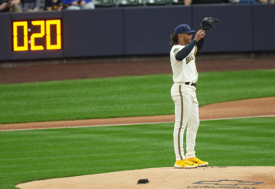 With the pitch timer in the distance, Milwaukee Brewers starting pitcher Freddy Peralta (51) stands on the mound during the first inning of their game against the New York Mets Monday, April 3, 2023 at American Family Field in Milwaukee, Wis.