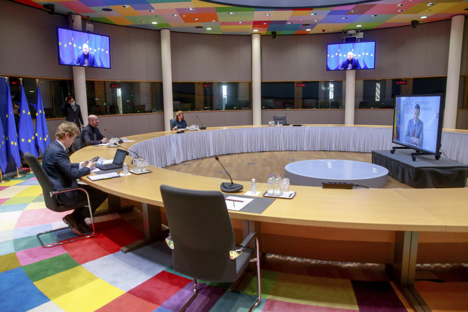 European Council President Charles Michel, second left, talks to Spanish Prime Minister Pedro Sanchez, right on a screen, during a video conference ahead of a EU summit at the European Council headquarters in Brussels, Wednesday, March 24, 2021. (Stephanie Lecocq, Photo Pool via AP)