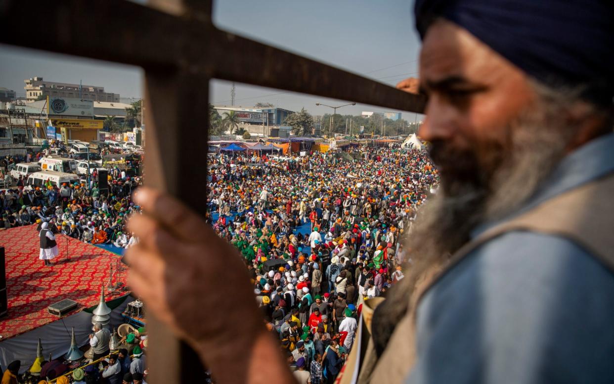 Protesting farmers listen to a speaker as they block a major highway during a nationwide shutdown called by thousands of Indian farmers protesting new agriculture laws - AP/AP