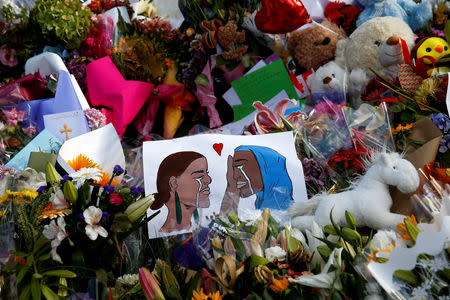 Flowers and cards are seen at the memorial site for the victims of Friday's shooting, outside Al Noor mosque in Christchurch, New Zealand March 19, 2019. REUTERS/Edgar Su