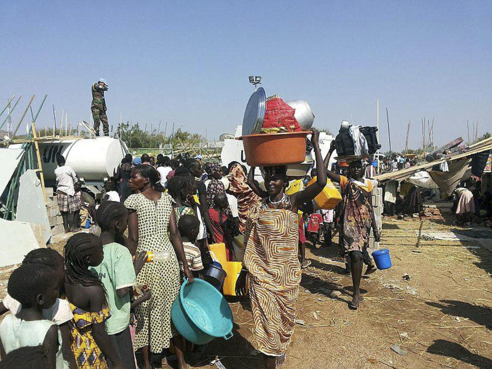 In this image released by the United Nations Mission Juba, civilians arrive at the compound of the United Nations Mission in the Republic of South Sudan (UNMISS), adjacent to Juba International Airport, to take refuge Wednesday, Dec. 18 , 2013, in Juba, South Sudan.(AP Photo/UNMISS, Rolla Hinedi)