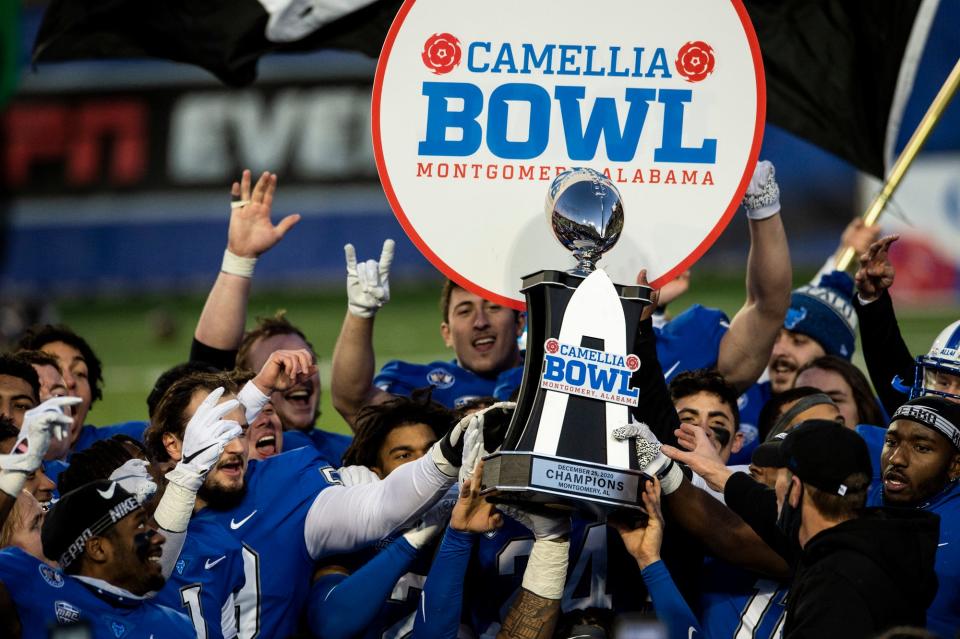 Buffalo players celebrate with the trophy after the Camellia Bowl at Cramton Bowl in Montgomery, Ala., on Friday, December 25, 2020. Buffalo defeated Marshall 17-10.