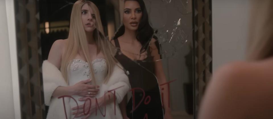 Emma Roberts as Anna and Kim Kardashian as Siobhan standing in front of a broken mirror in "American Horror Story: Delicate."