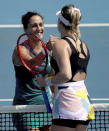 Italy's Martina Trevisan, left, is congratulated by Canada's Eugenie Bouchard after winning their women's singles qualifying match for the Australian Open tennis championship in Melbourne, Australia, Friday, Jan. 17, 2020. (AP Photo/Lee Jin-man)