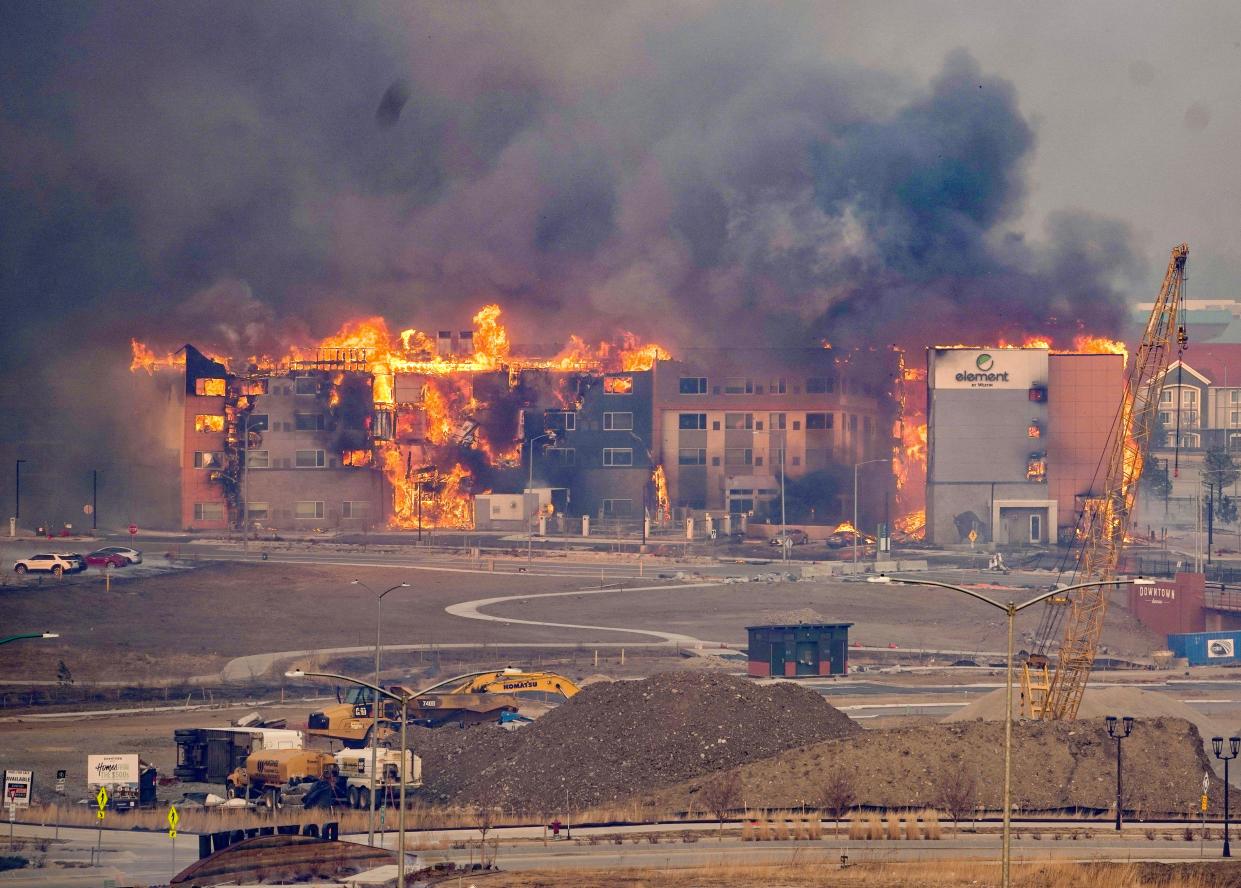 In the old town area of Superior, Colorado, multiple buildings and vehicles are on fire, including an Element  hotel.