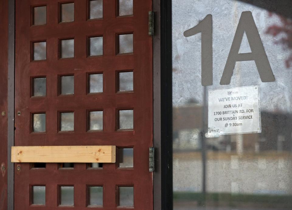 Paper signs are posted at the entrances informing members of The Word Church that the church has moved.