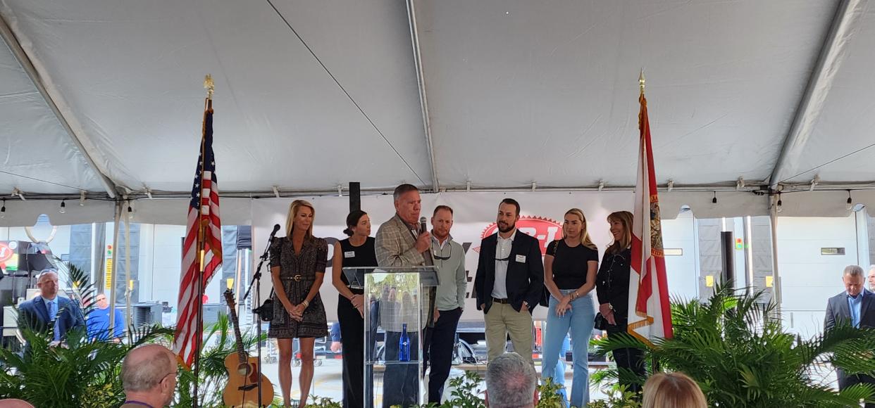 Cheney Brothers CEO Byron Russell, with members of his family behind him, addresses the crowd at the grand opening of a new facility in Port St. Lucie on Jan. 30, 2024.