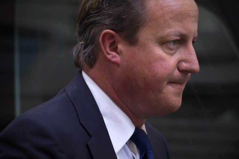 British Prime Minister David Cameron arrives at 10 Downing Street in central London on August 27, 2013, after returning early from a holiday to address the Syria crisis. Bashar al-Assad's friends and foes headed for a showdown at the United Nations Wednesday, as Britain pushes for a resolution to pave the way for military strikes over suspected chemical attacks