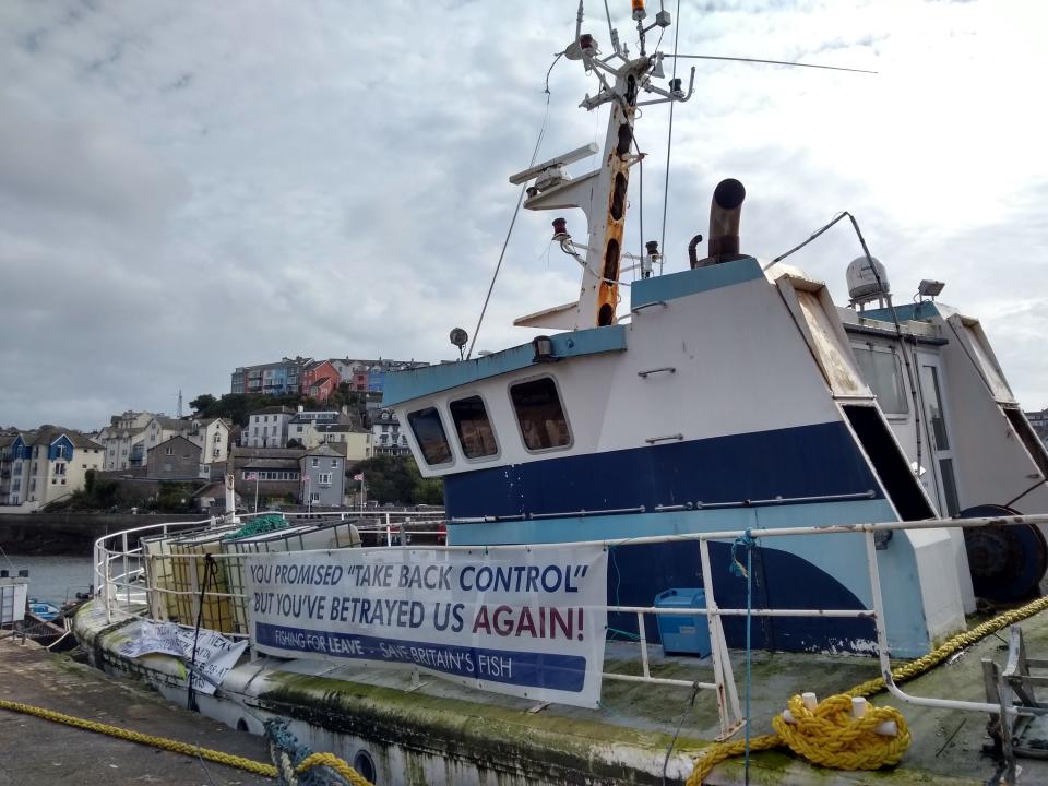 A picture shows a 'Fishing For Leave' campaign group sign about Brexit on a boat in the harbour in Brixham, southern England, on October 11, 2018. - Tensions are already high between the French and British fishing fleets due to the scallop wars but Brexit could change the game completely by redrawing the battle lines in the Channel. French fishermen are anxious to avoid a hard Brexit that could shut them out of British territorial waters, while in UK ports, trawlermen hope such moves could reinvigorate the British fishing industry. (Photo by Robin MILLARD / AFP)        (Photo credit should read ROBIN MILLARD/AFP/Getty Images)