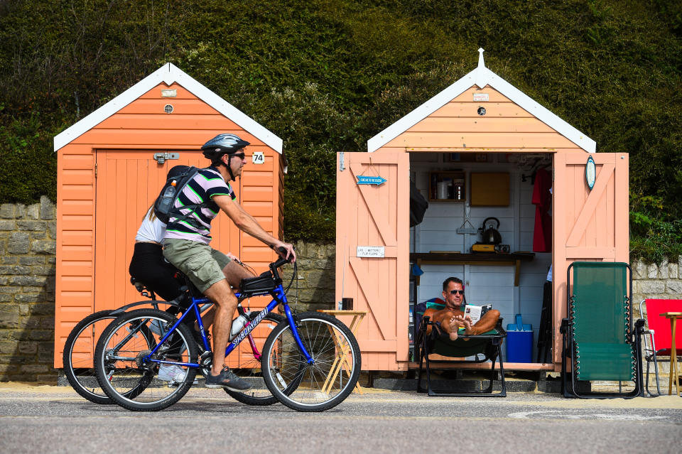 Stuart Henderson enjoys the Autumn sunshine from his beach hut on Bournemouth beach.