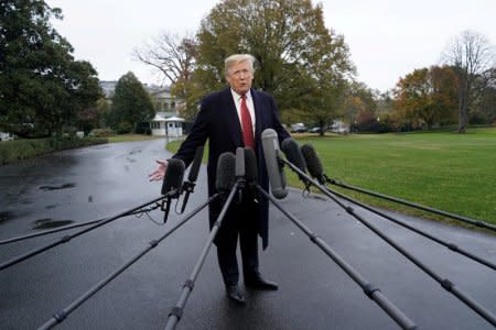 FILE PHOTO: U.S. President Donald Trump talks to reporters prior to departing for Paris, France from the South Lawn of the White House for in Washington, U.S., November 9, 2018. REUTERS/Kevin Lamarque/File Photo