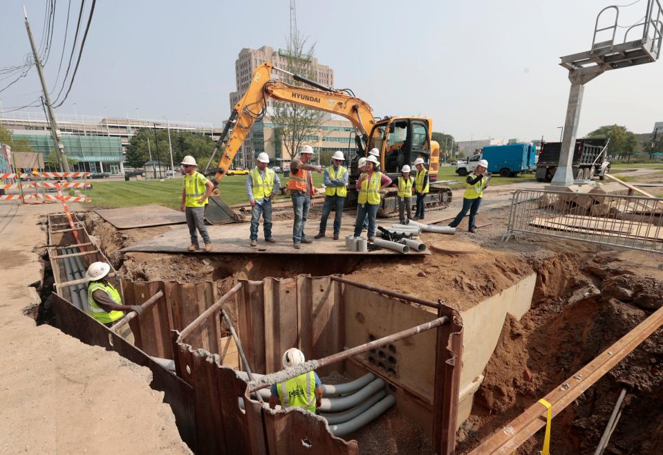 Work goes on laying new pipe and underground electrical near the Wayne State University campus area in Detroit on July 25, 2023.