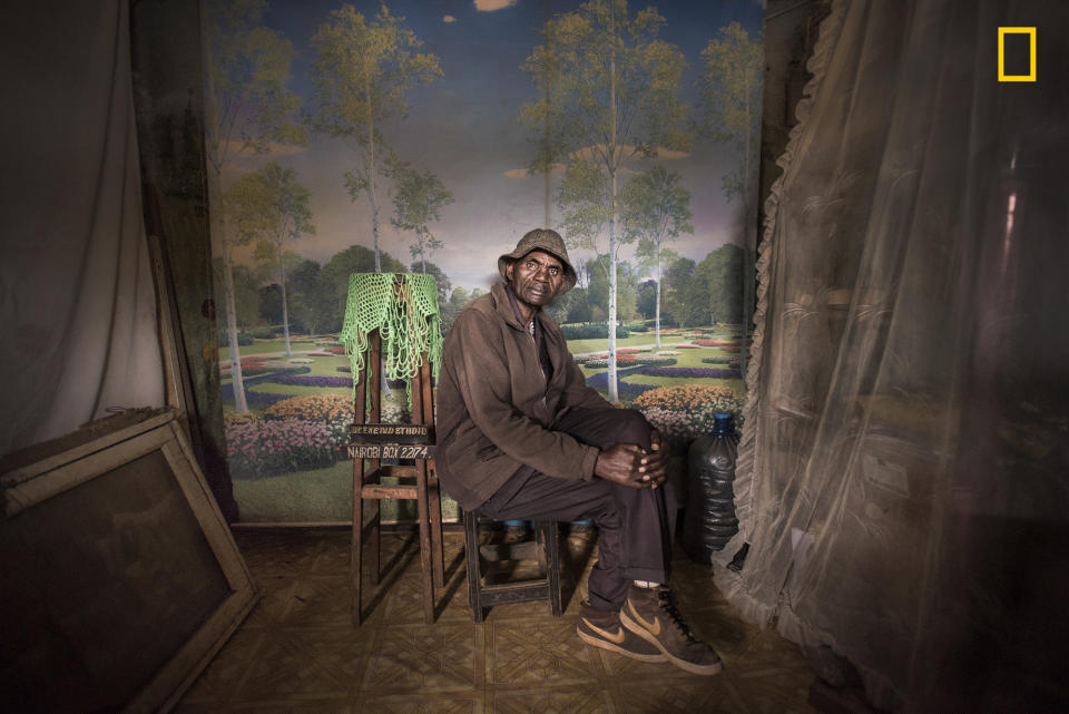 I was looking to do a series of portraits showing people wearing their Sunday best when I made this photo of David Muyochokera. It was taken on his last Sunday working as a photographer at Weekend Studio, in Kibera&mdash;a large shantytown in Nairobi, Kenya. My friend Peter, a local resident, had pointed me to the photo studio just as I was about to leave the area. It was a stunning space, with whimsical backdrops and natural light coming through the doorway. David had worked there for 37 years, but Weekend Studio was about to close permanently. Phone cameras were so common now, he said, and fewer people wanted studio portraits. David planned to retire and return home to the countryside. I&nbsp; was troubled by the studio&rsquo;s imminent closure, so I eventually took over the rent. A portrait of David now hangs at Weekend Studio in his memory.