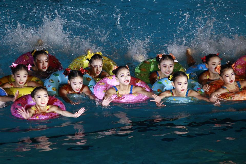 A group of synchronized swimmers perform celebrating the Day of Shining Star on the occasion of the 80th birth anniversary of former North Korean leader Kim Jong Il at a swimming gymnasium in Pyongyang, North Korea, Sunday, Feb. 13, 2022. (AP Photo/Cha Song Ho)