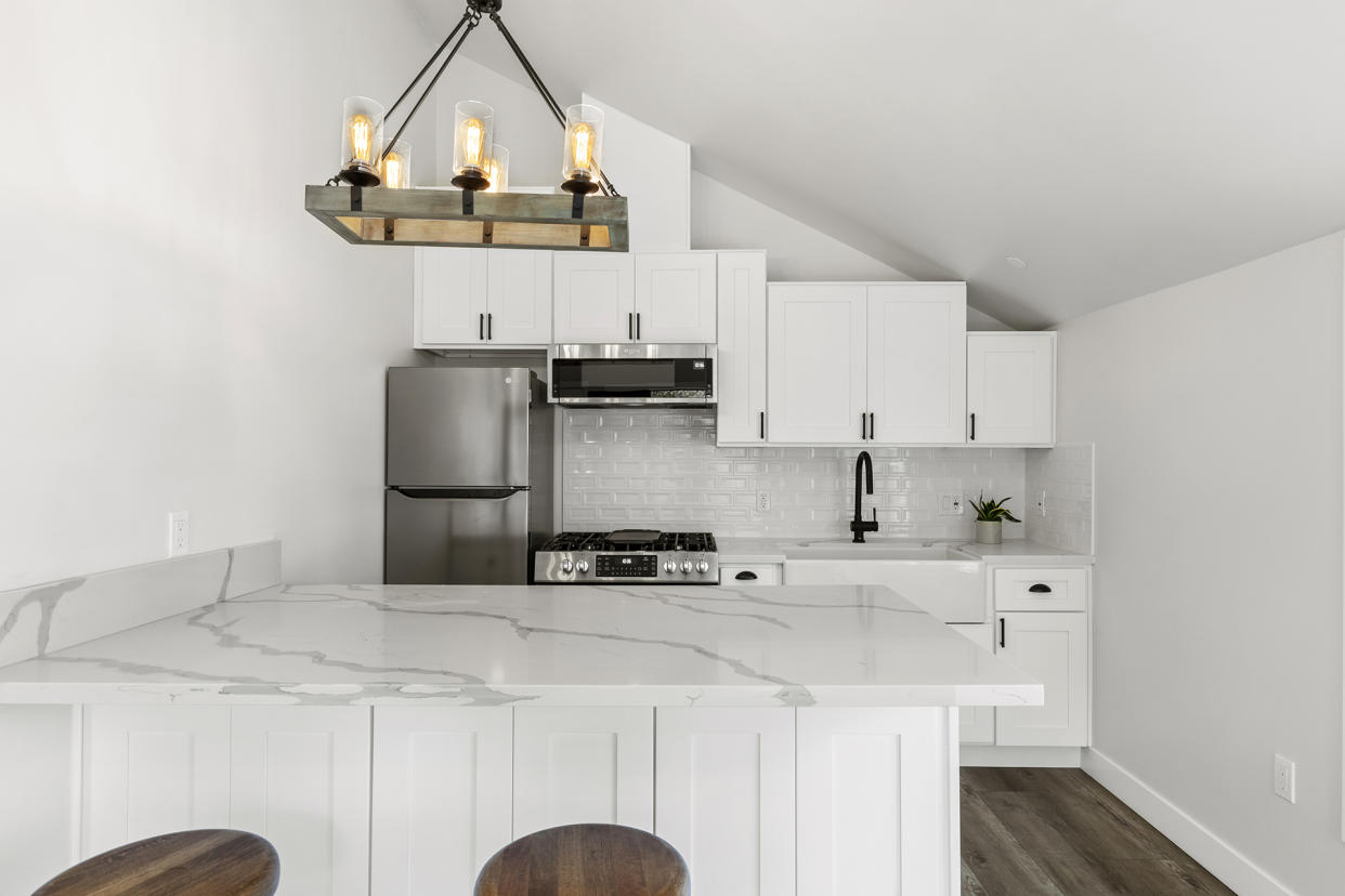 This marble-accented kitchen is in a 600-square-foot home built by Maxable in California.