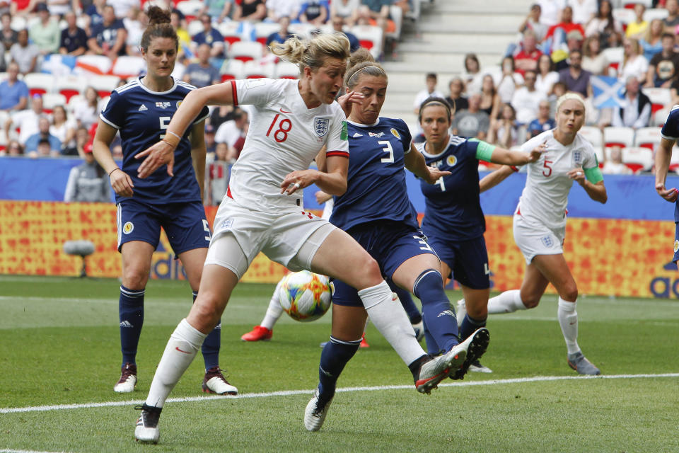 England's Ellen White, left, and Scotland's Nicola Docherty compete for the ball during the Women's World Cup Group D soccer match between England and Scotland in Nice, France, Sunday, June 9, 2019. (AP Photo/Claude Paris)