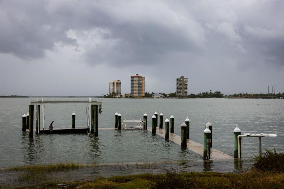 Water rises above the docks at Fort Myers Beach as Hurricane Idalia approaches on Tuesday.