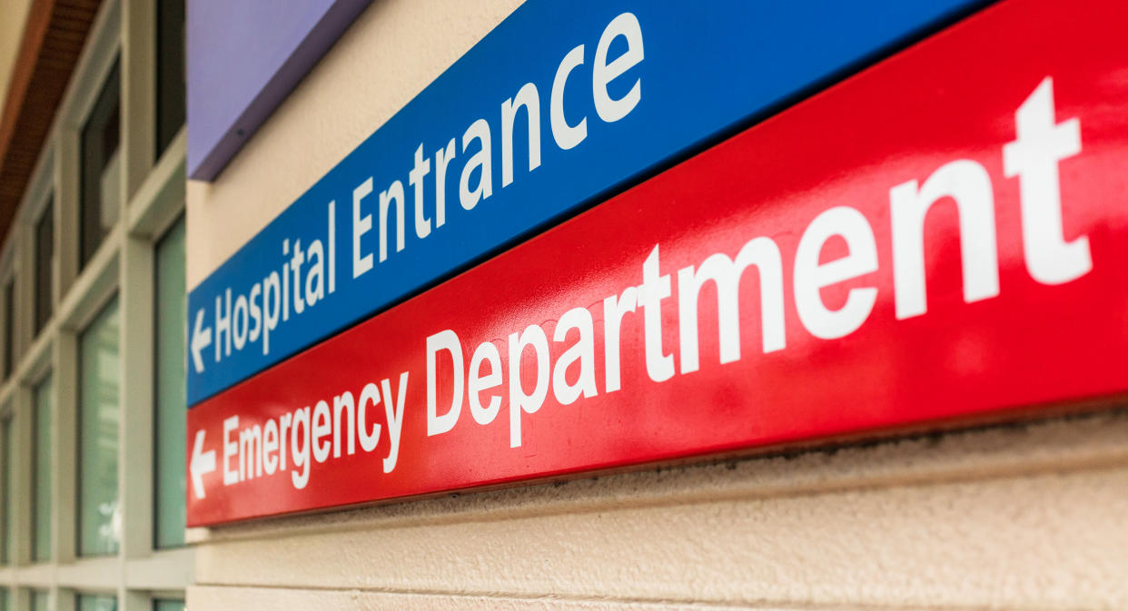 A hospital sign in London, giving directions towards the emergency department.