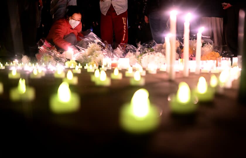 Los Angeles, California November 29, 2022-A woman lights a candle during a vigil for victims who suffer under China's stringent lockdown in Urumqi and COVID victims on the campus of USC Tuesday night. (Wally Skalij/Los Angeles Times)
