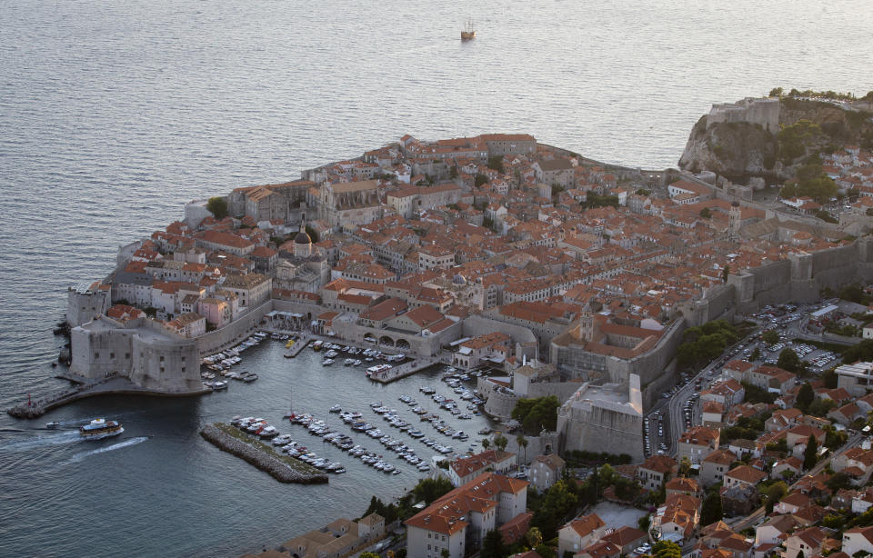 This Sept. 4, 2018 photo shows the old town of Dubrovnik from a hill above the city. Crowds of tourist are clogging the entrances into the ancient walled city, a UNESCO World Heritage Site, as huge cruise ships unload thousands more daily. (AP Photo/Darko Bandic)