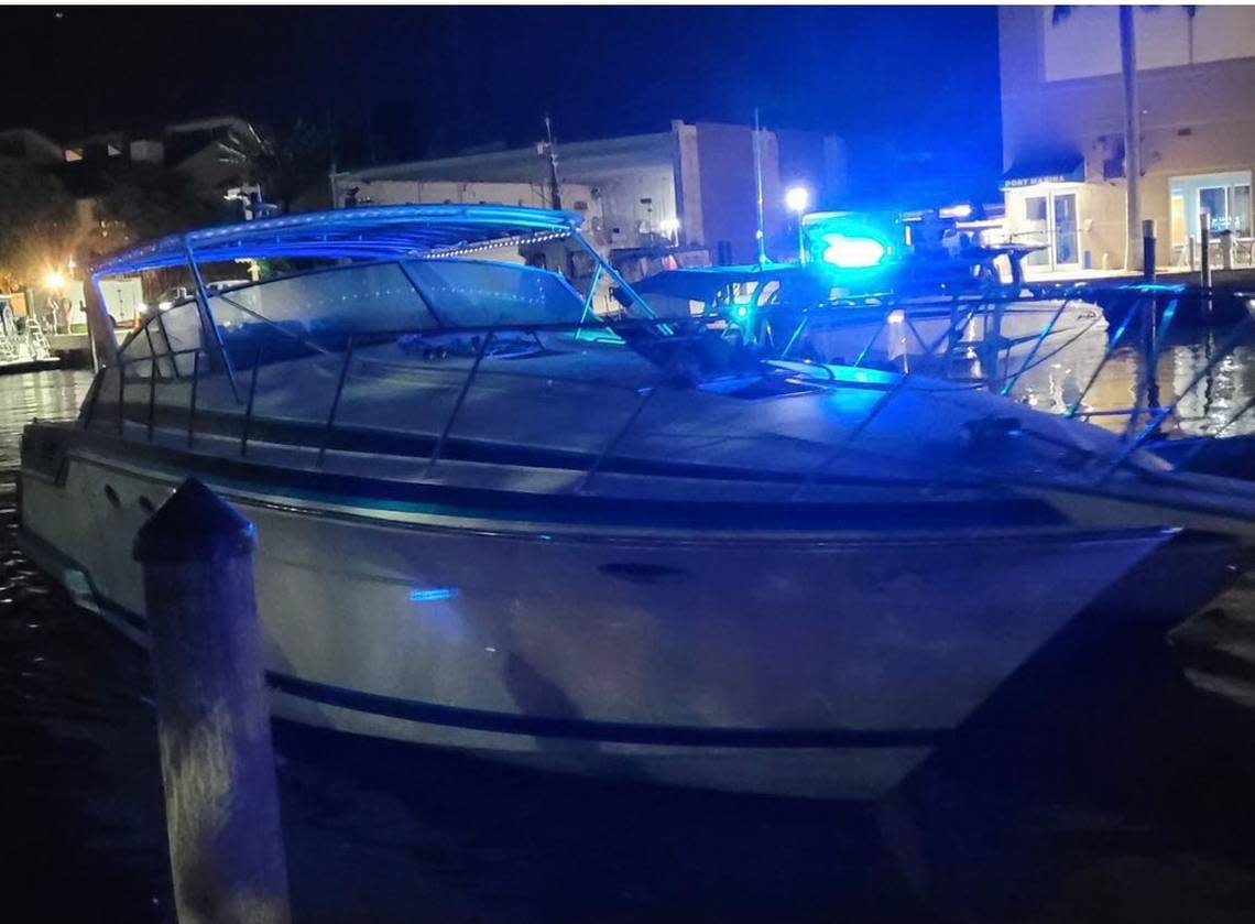 A yacht that U.S. Border Patrol says brought a dozen migrants to a Fort Lauderdale beach is docked at a marina Tuesday night, Jan. 10, 2022.