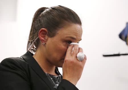 A television journalist wipes a tear away, during a news conference by St Vincent's Hospital medical staff and Australian cricket representatives on the death of Australian cricketer, Phillip Hughes, in Sydney, November 27, 2014. REUTERS/Jason Reed