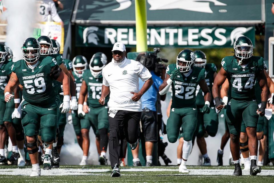 Michigan State interim head coach Harlon Barnett leads the players onto the field before the game against Maryland at Spartan Stadium in East Lansing on Saturday, Sept. 23, 2023.