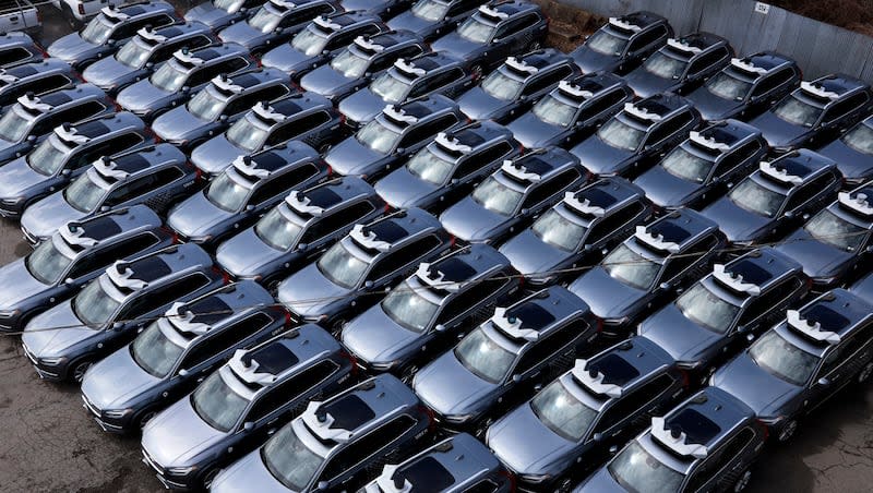 This March 20, 2020, photo shows a parking lot full of Uber self-driving Volvos in Pittsburgh.