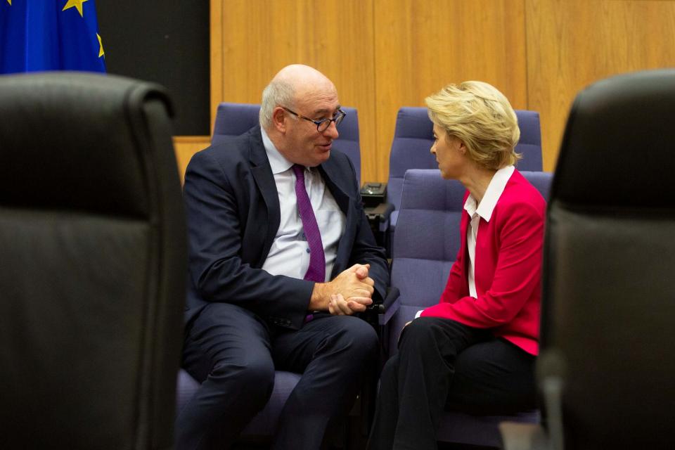Ursula von der Leyen speaks with Phil Hogan at the EU's headquarters in Brussels (AP)