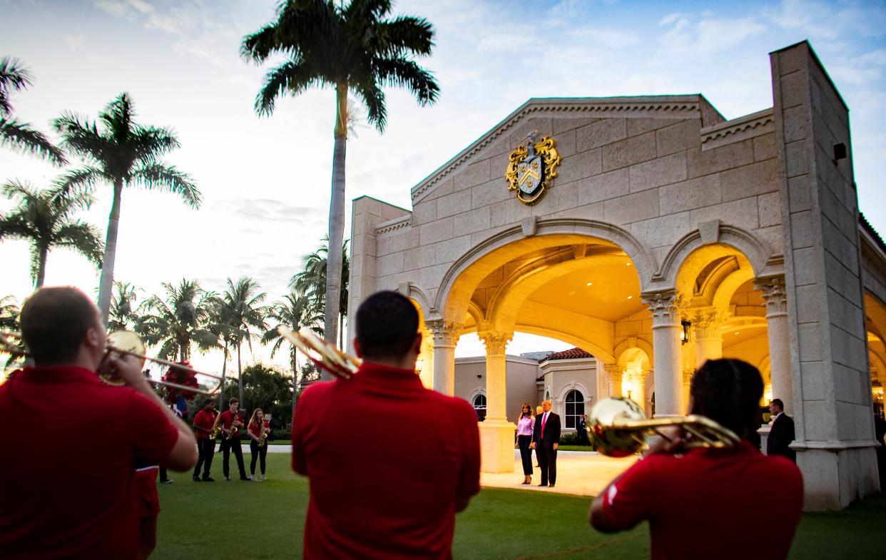 President Donald Trump and first lady Melania watch the Florida Atlantic University marching band perform outside Trump International Golf Club on February 3, 2019 before Trump's annual Super Bowl watch party at his golf club in unincorporated West Palm Beach.