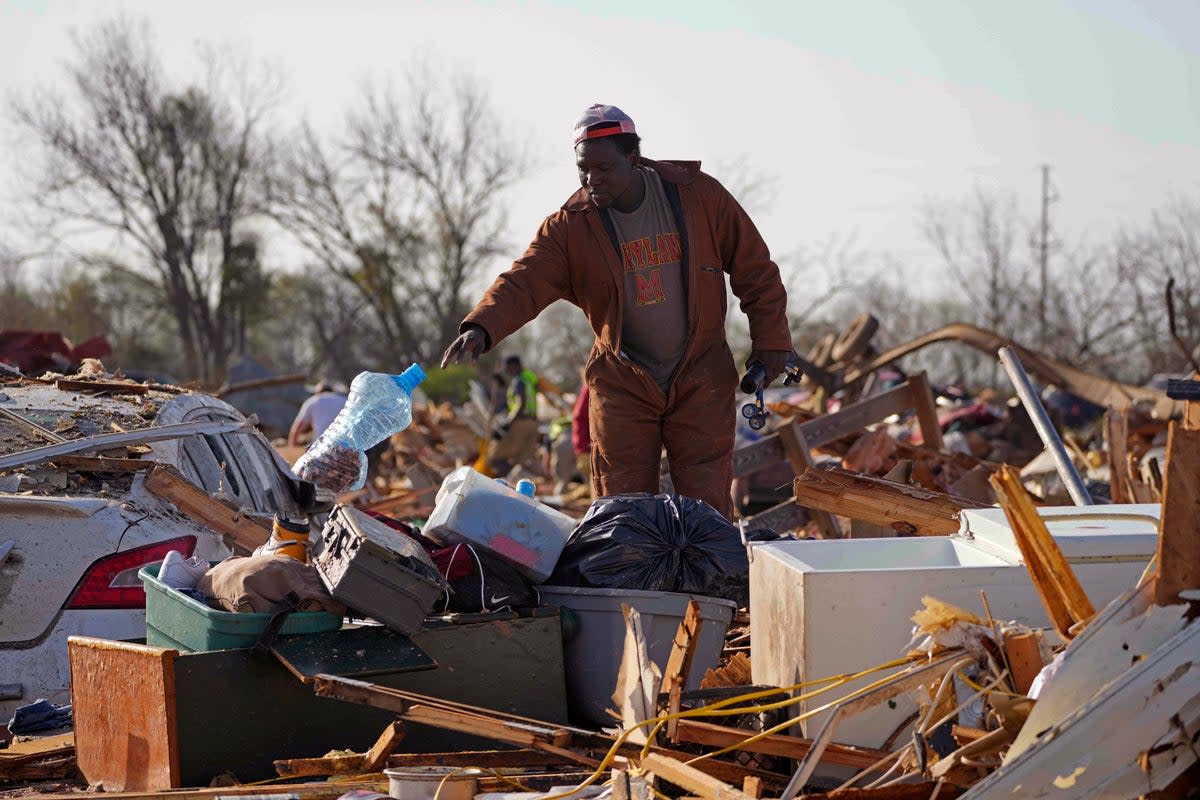 A Mississippi resident surveys the damage after a tornado cut a 170-mile path through the state and neighboring Alabama (AP)