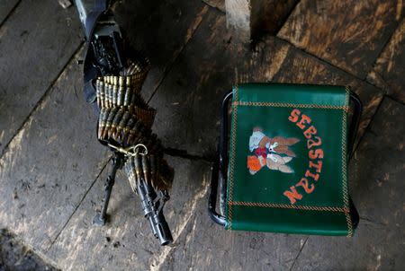 A machine gun and a chair are pictured in at a camp of the 51st Front of the Revolutionary Armed Forces of Colombia (FARC) in Cordillera Oriental, Colombia, August 16, 2016. REUTERS/John Vizcaino