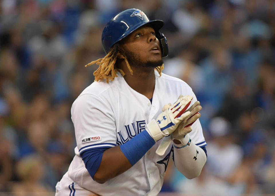 Jun 19, 2019; Toronto, Ontario, CAN;  Toronto Blue Jays third baseman Vladimir Guerrero Jr. (27) reacts after earning a walk against Los Angeles Angels in the third  inning at Rogers Centre. Mandatory Credit: Dan Hamilton-USA TODAY Sports