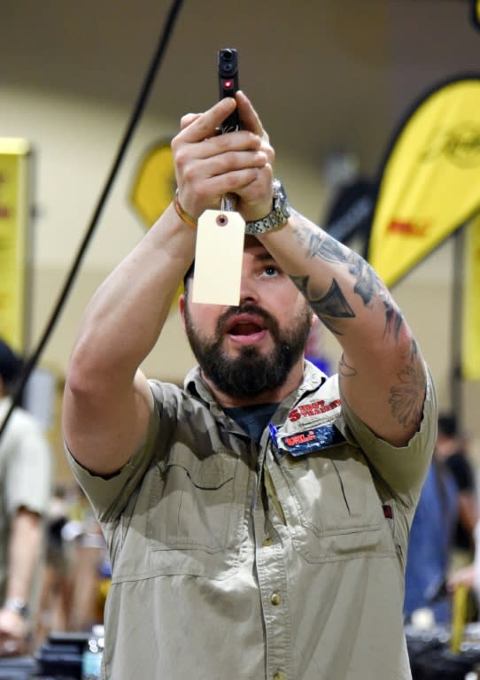 A man checks out a weapon at the South Florida Gun Show