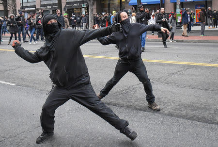 Protestors throw rocks at police during a protest near the inauguration of President Donald Trump in Washington, DC, U.S., January 20, 2017. REUTERS/Bryan Woolston