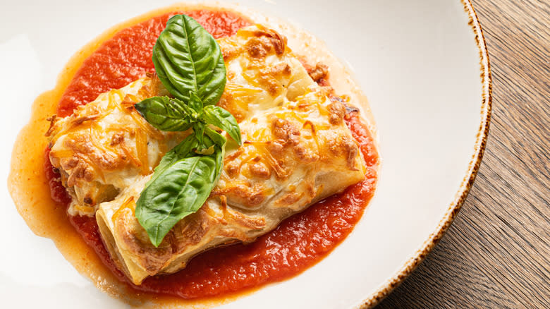 Garnished lasagna roll with sauce