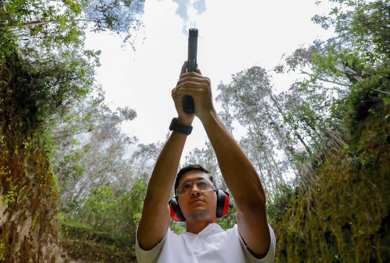 Kevin Paredes, de 28 años, posa para una fotografía durante una clase de tiro, mientras un número creciente de ecuatorianos está aprendiendo a usar armas de fuego con la esperanza de protegerse, estimulados por el aumento de los delitos violentos y el aumento de la actividad de las pandillas, en Quito, Ecuador