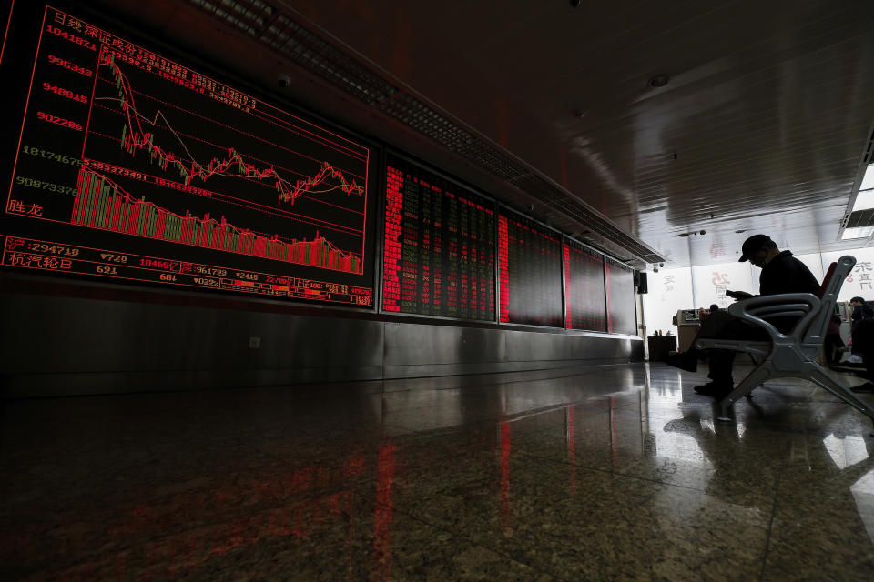 A Chinese investor monitors stock prices at a brokerage house in Beijing, Wednesday, Oct. 23, 2019. Asian stock markets followed Wall Street lower Wednesday after major companies reported mixed earnings and an EU leader said he would recommend the trade bloc allow Britain to delay its departure. (AP Photo/Andy Wong)