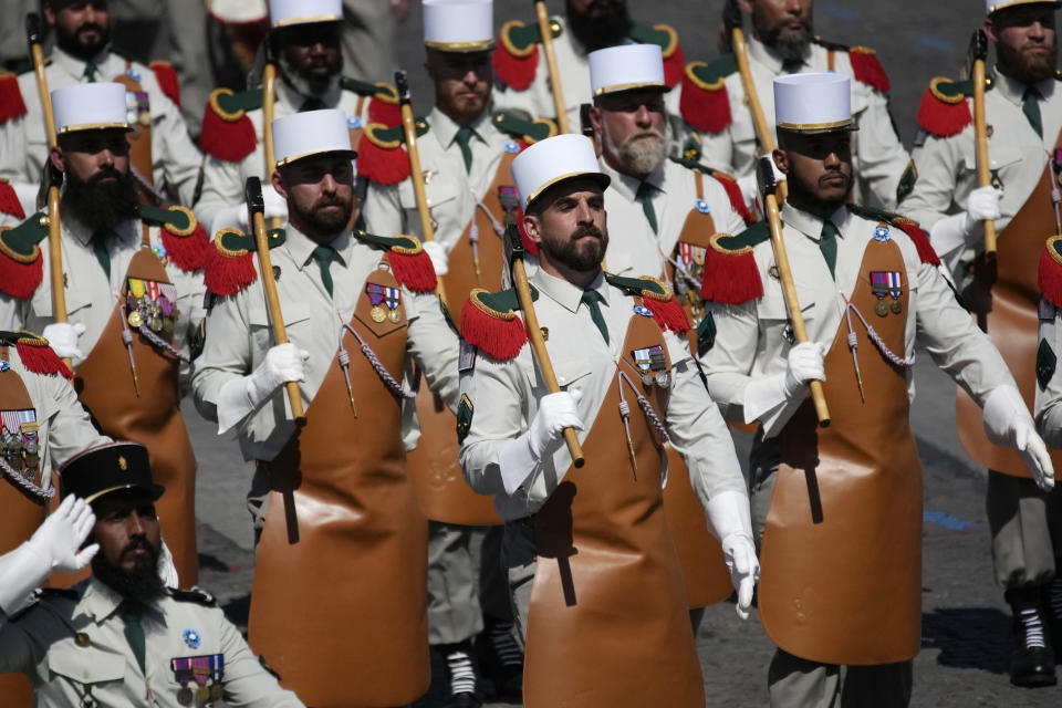 Soldiers from the Foreign Legion march on the Champs-Elysees avenue during the Bastille Day parade in Paris, Friday, July 14, 2023. (AP Photo/Christophe Ena)