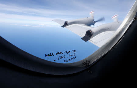 FILE PHOTO - Hand-written notes on how a crew member should report the sighting of debris in the southern Indian Ocean is pictured on a window aboard a Royal New Zealand Air Force P-3K2 Orion aircraft searching for missing Malaysian Airlines flight MH370, March 22, 2014. REUTERS/Jason Reed/File Photo